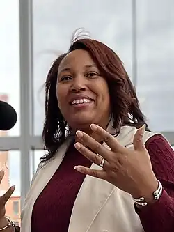 Headshot of Freeman gesturing against a white background