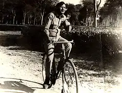 sepia image of Dhiru Bhuyan riding a bicycle