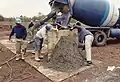 Shaping the concrete boulders.