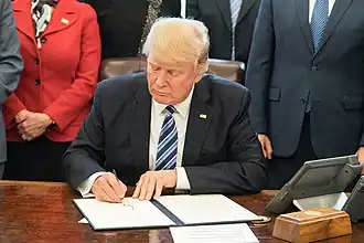 The call button in a wooden box next to Donald Trump's telephone on the Resolute desk in March 2017