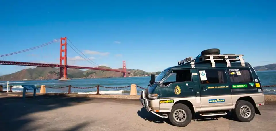 The Driven to Sustain van parked along the San Francisco waterfront with the Golden Gate Bridge in the background.