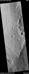 Channel that has eroded through a wrinkle ridge, as seen by HiRISE under HiWish program Arrow shows point where channel eroded through ridge.