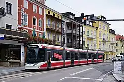 Five-section red white and grey tram