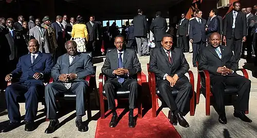 Five presidents seated on chairs in an outdoor scene with sunshine and a red carpet: Yoweri Museveni of Uganda, Mwai Kibaki of Kenya, Paul Kagame of Rwanda, Jakaya Kikwete of Tanzania and Pierre Nkurunziza of Burundi