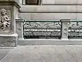 Sidewalk moat railing next to the main entry