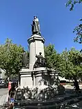 Statue of King Edward VII aligned underneath the daytime moon.