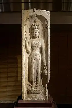 Tang dynasty (618-907) Chinese limestone-carved relief of Shiyimian Guanyin from Baoqing Temple in Xi'an, Shaanxi, China. Dated to 703. Held at the Tokyo National Museum in Tokyo, Japan.