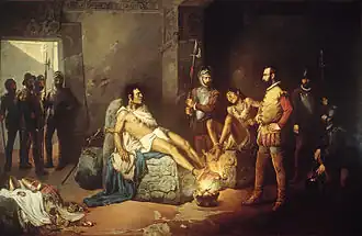 Depicted is the 1892 oil-on-canvas painting "El suplicio de Cuauhtémoc" by artist Leander Izaguirre, Spanish for "The Torture of Cuauhtémoc", which depicts a non-contemporary artistic interpretation of Cortés' torture of the Mexica tlatoani Cuauhtémoc. In the painting he and another compatriot are depicted with their bodies bound to engraved pieces of stone, and their feet chained to be in close contact with a raging flame coming off of a cauldron of charcoal. Cuauhtémoc, to the left, is depicted stoically, despite his feet being the closest to the fire, showing little reaction, while his compatriot is shown cowering in fear, having jerked his feet back from the fire. The latter looks up at a guard to the center-right background, who looks on in disdain, while in the foreground center-right, Hernán Cortés looks leftward at Cuauhtémoc rather neutrally. Cuauhtémoc's gaze is focused on his compatriot. There are various other Spanish dignitaries and guards in the background.