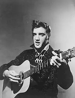 Publicity photo of Elvis playing guitar