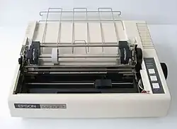 A beige, Epson-branded dot matrix printer with its lid opened, exposing its friction-feed platen