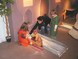 Two children in smocks by a ramp