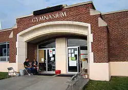 A brick building with people sitting out front