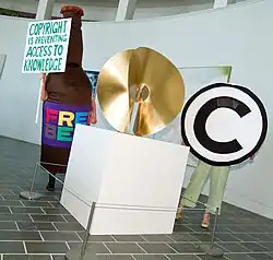 Anti-copyright display with a "Free Beer version 3.2 St. Austell" mascot and a sign reading "Copyright is preventing access to knowledge" (2007)