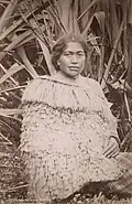 Māori woman wearing the traditional costume made of flax fibre, c. 1880