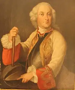 Portrait shows a be-wigged man in a white (possibly military) coat with large red cuffs.