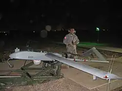 Sgt. Neal Naputo, a native of Zambales, Philippines, prepares to launch an unmanned aerial vehicle at Camp Taji, northwest of Iraq, 15 November.