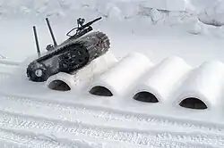 A robotic vehicle undergoes mobility testing on a bump course at ARTC.