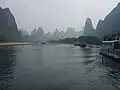 Tall karst mountains in the mist seen from the Li river