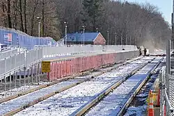 A high level platform left of two railroad tracks