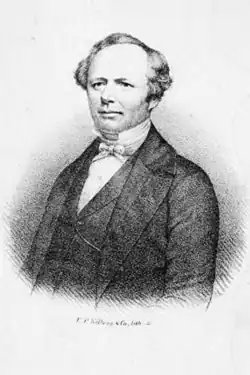 19th-century B&W half-length portrait photo of an old man with a receding hairline, wearing a dark suit, white shirt, and bow tie.