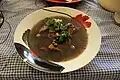 Frijol con puerco (beans with pork) prepared with beans, pork, epazote, onion, cilantro, lemon, radishes and habanero chile