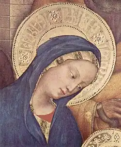 Pseudo-Arabic script in the Virgin Mary's halo, detail of Adoration of the Magi (1423) by Gentile da Fabriano. The script is further divided by rosettes like those on Mamluk dishes.[24]