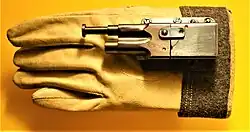 The Sedgley OSS .38 "Glove pistol." This was a pistol strapped to a glove developed primarily by the Office of Naval Intelligence and distributed in OSS Weapons.