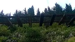 The state of the railway line passing through the Goukamma Valley showing sections of the slope that have collapsed leaving the rails suspended in the air.