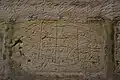 Graffiti etched into the walls by the prisoners