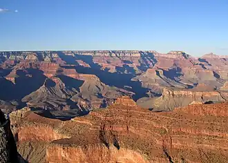 O'Neill Butte, (above Supai Group 'redbeds'), on ridgeline from Yaki Point; (Newton Butte prominence off photo, right) View northeast, with Cape Royal (point) on Walhalla Plateau (Kaibab Plateau), and flat-top of Wotans Throne and Vishnu Temple prominence. (from Yavapai Point, west of Yaki Point, South Rim)