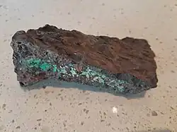 Slag specimen from the Great Cobar mine, with colouration due to the presence of copper.