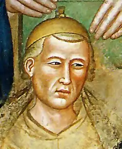 Fresco of a man with light-colored hair wearing a scholarly attire
