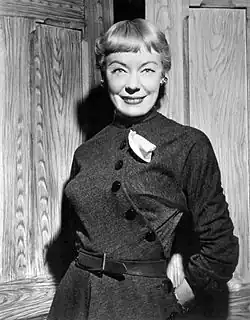 A woman in a dress, smiling