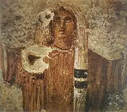Stage two, the girl becomes a consecrated virgin, praying in the orante-style pose.[17]