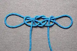 Handcuff knot "locked" with half hitches, this is also known as the Fireman's chair knot