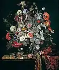 A Still Life of Flowers in a Glass Vase on a Marble Ledge Partly Draped with a Carpet
