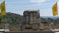 Vertical versions of the Hezbollah flag flying at the Tomb of Hiram