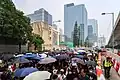 Marchers on Hoi Bun Road, many holding umbrellas to protest street surveillance