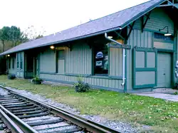 Rear view of Holland Patent Railroad Station, showing train tracks.