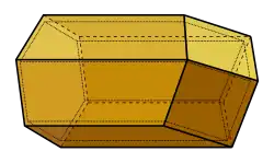 A diagram showing the 3D structure of a honeycomb cell, consisting of a hexagonal face on the left hand side connected to three rhombic faces on the right by six flat quadrilateral surfaces