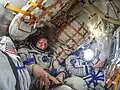 Korniyenko (right), Padalka (center) and Kelly (left) inside the spacecraft prior to the relocation maneuver.