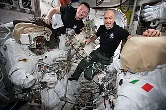 Morgan and ESA commander Luca Parmitano checking U.S. spacesuits and spacewalking tools