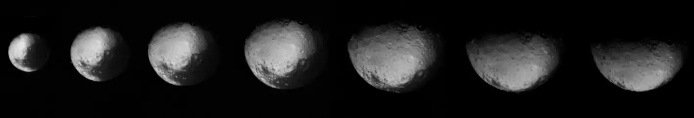 This series of images of Iapetus' north pole by Voyager 2 became the first-ever hints on the existence of the moon's equatorial ridge. The white and grey dots below each images (Iapetus' equator) will later be revealed to be Carcassone Montes[1] (Voyager Montes) by Cassini.[13] Taken on August 22, 1981.