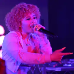 Ice Spice singing into a mic