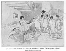Engraving showing six young men in nightshirts standing before a boy in a nightshirt sitting on a bed. Everybody is disheveled. One of the young men is putting an upside-down hat before the boy. Others are doing antics. Another alarmed boy is hiding between two mattresses. Just his head is visible.