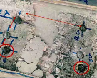 A damaged concrete slab showing incorrect distances concerning stud placement.