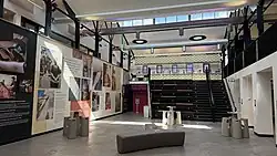 An airy, modern building with natural light and displays on the walls