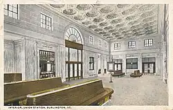 A postcard view of a waiting room in a railway station