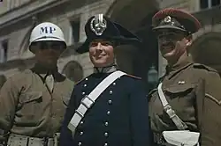 An Italian Carabiniere wearing bicorne (centre), alongside American (left) and British (right) military policemen, 1944.