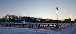 the sun setting behind the Rock the River Winter Festival
